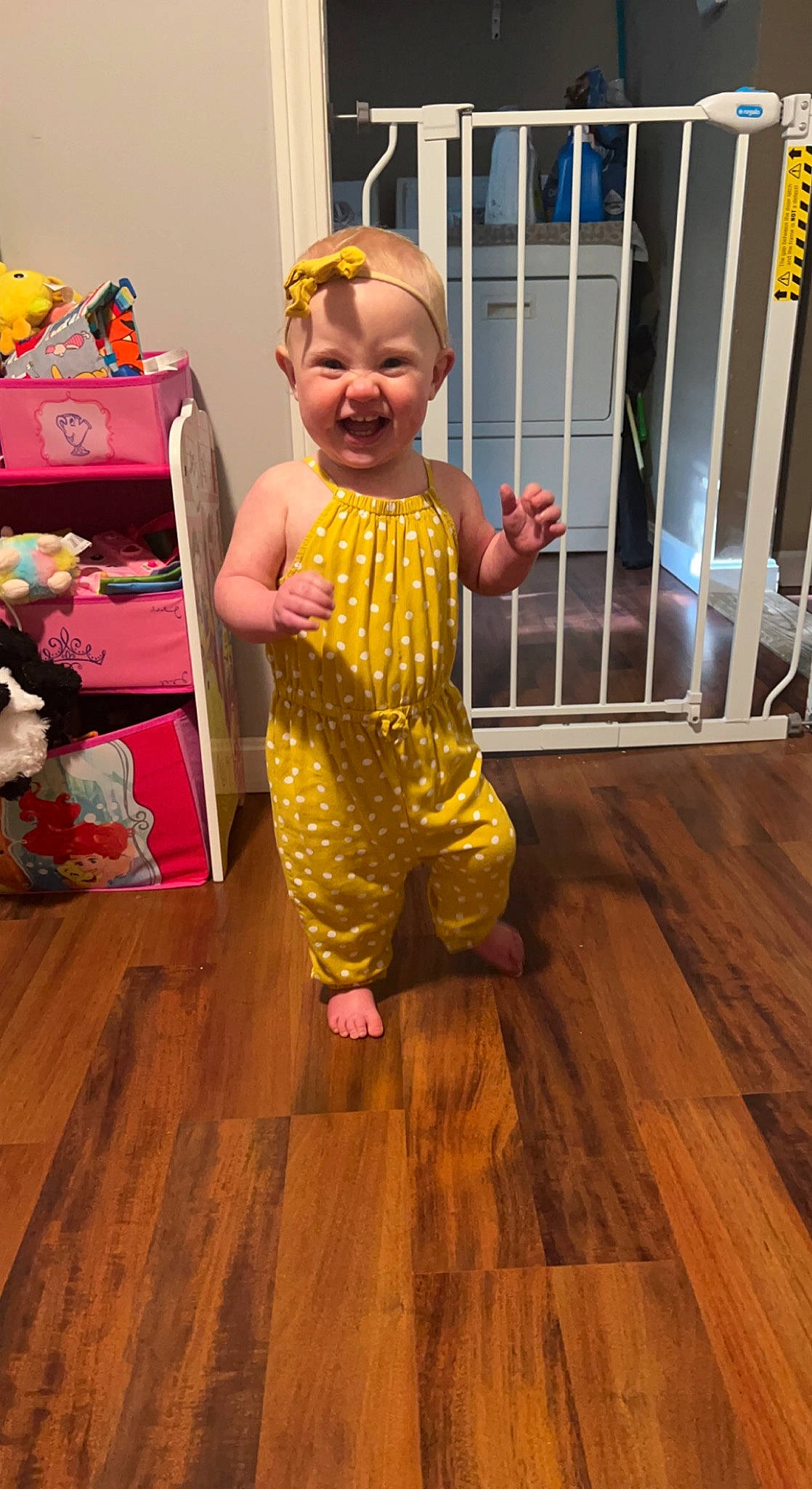 Kara is registered to the contest to win money with this photo: baby, baby_toddler_clothing, child, event, fence, floor, flooring, fun, happy, hardwood, joy, laminate_flooring, person, plank, room, smile, toddler, varnish, wood, wood_flooring