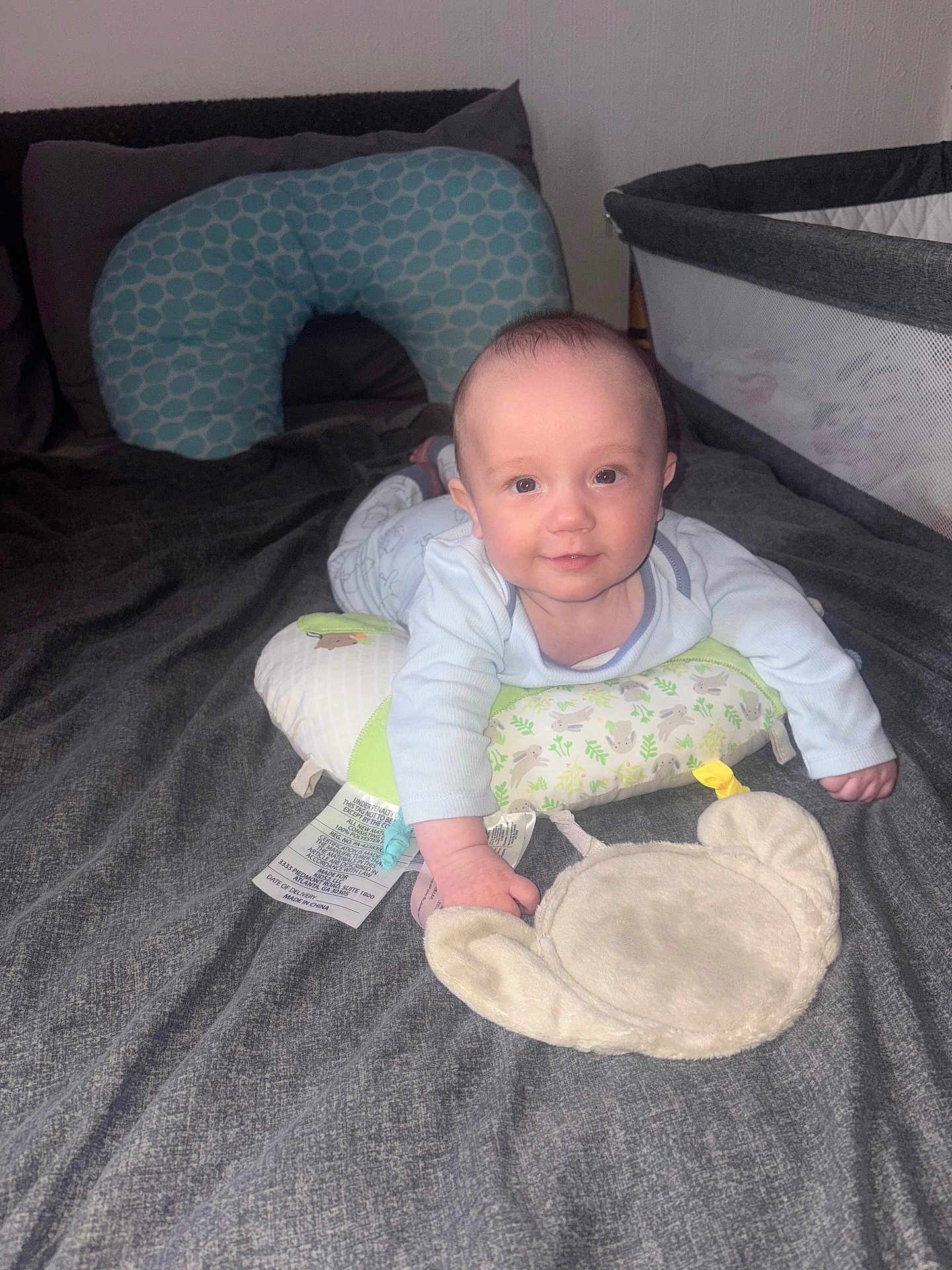 Leo joined the competition — help win amazing prizes! baby, bed, pillow, plush_toy, crib, infant, smile, looking_at_camera, blanket, clothing, indoor, person, cute, child, soft_toy, nursing_pillow, furniture, home, sleeping_area, baby_girl
