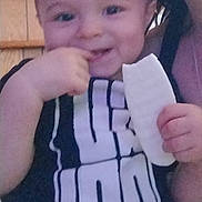 Beau joined the competition — help win amazing prizes! toddler, child, smiling, food, hand, shirt, text, person, indoor, face, baby, young_child, holding, black_clothing, white_text, portrait, cute, happy, eating, casual