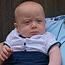 baby, blue_eyes, blue_pants, casual_wear, child, closeup, clothing, expression, face, hand, holding, infant, outdoor, person, portrait, serious, skin, white_shirt, wood_background, young