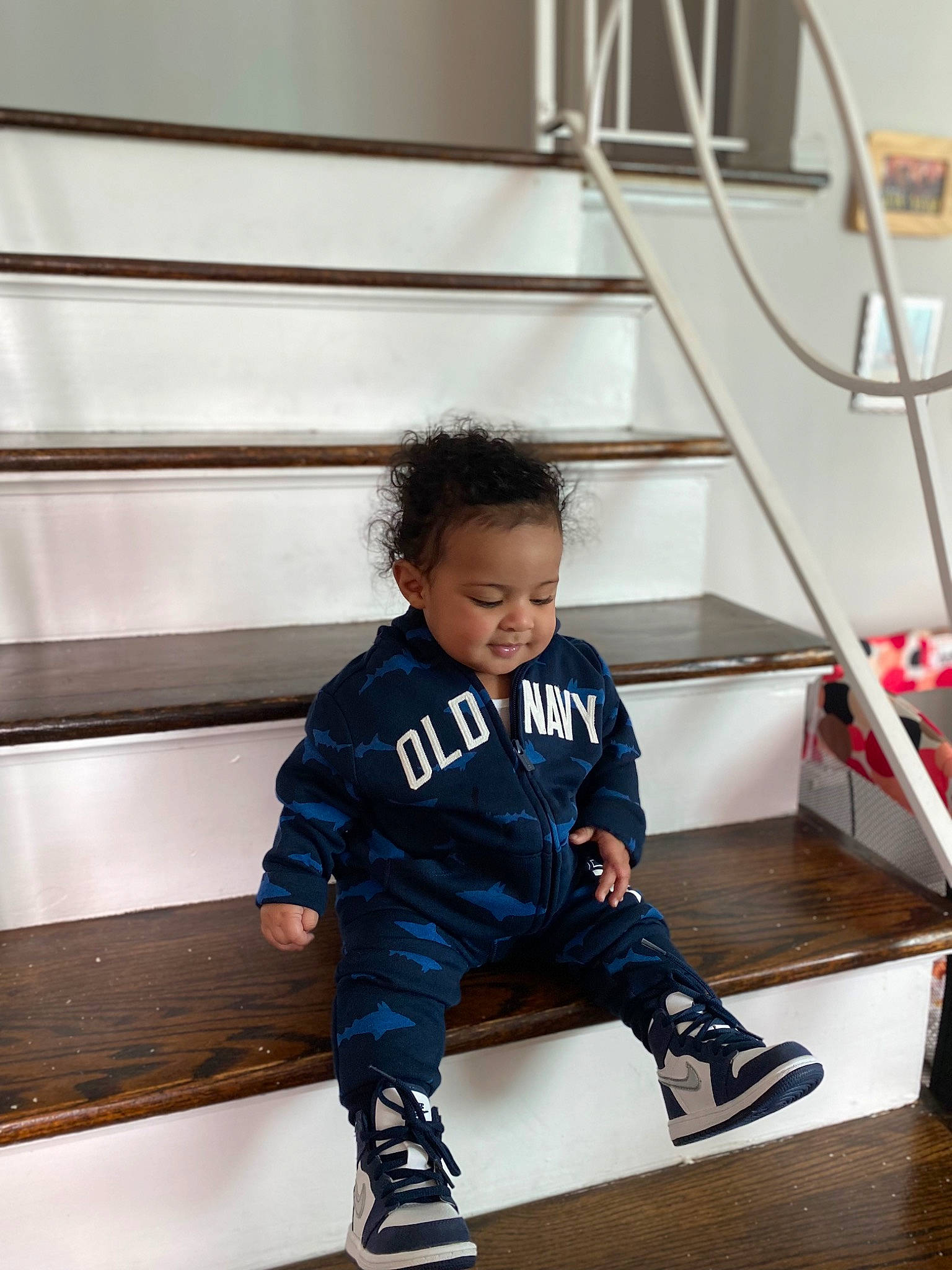 Jlani is registered to the contest to win money with this photo: boot, child, electric_blue, flooring, fun, hardwood, jacket, knee, leisure, outdoor_shoe, person, shoe, shorts, sitting, sock, sportswear, stairs, standing, t_shirt, toddler