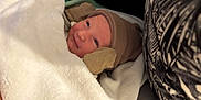 Lyam participe au concours pour gagner de l'argent avec cette photo : newborn, baby, blanket, hat, mittens, smile, face, infant, cozy, soft, warm, bed, sleepwear, person, cute, portrait, resting, comfort, clothing, wrapped