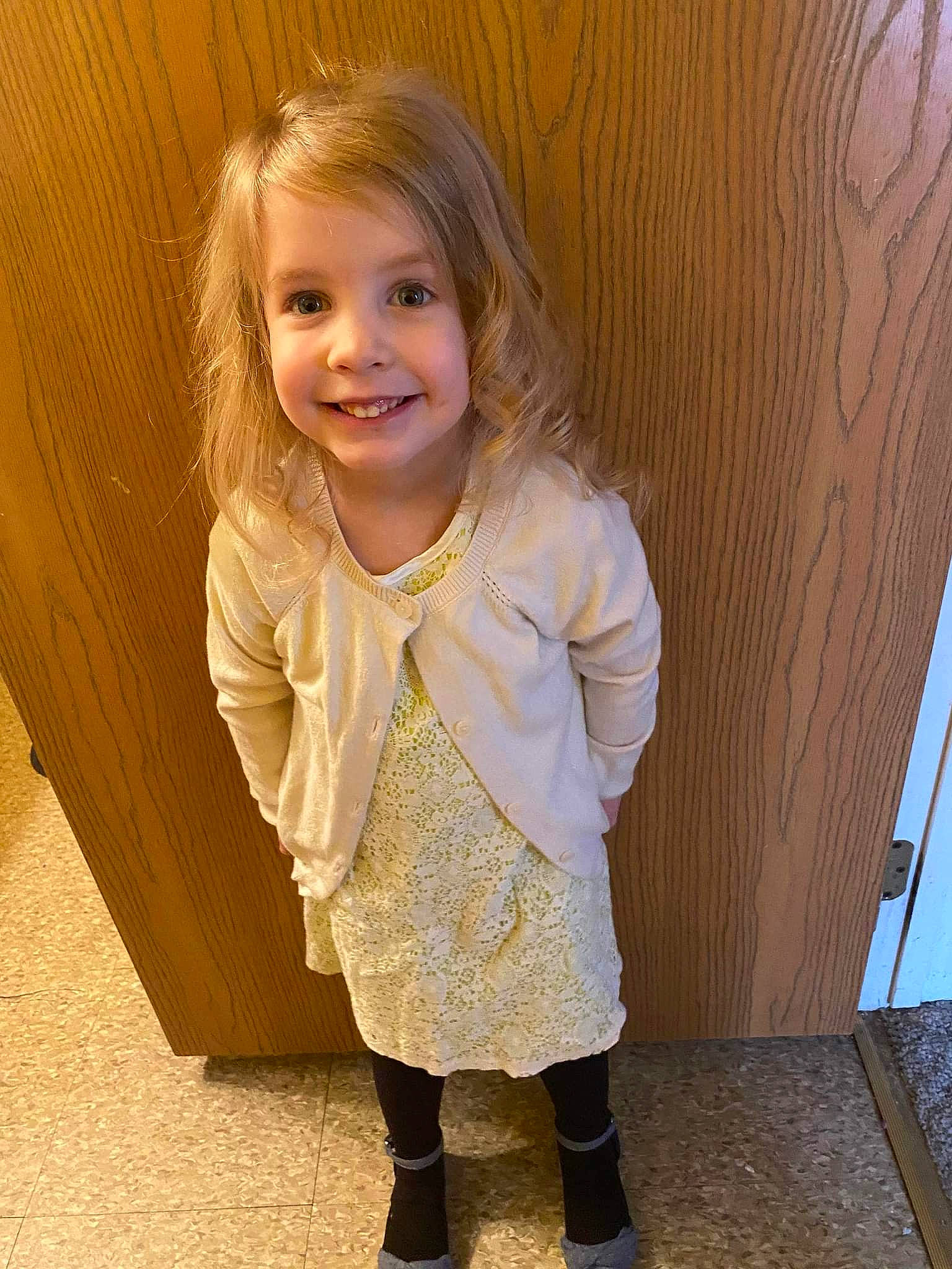 Rayna joined the competition — help win amazing prizes! baby_toddler_clothing, blond, brown_hair, cheek, child, clothing, dress, flooring, fun, grass, happy, hardwood, joy, outerwear, person, sitting, skin, sleeve, smile, standing