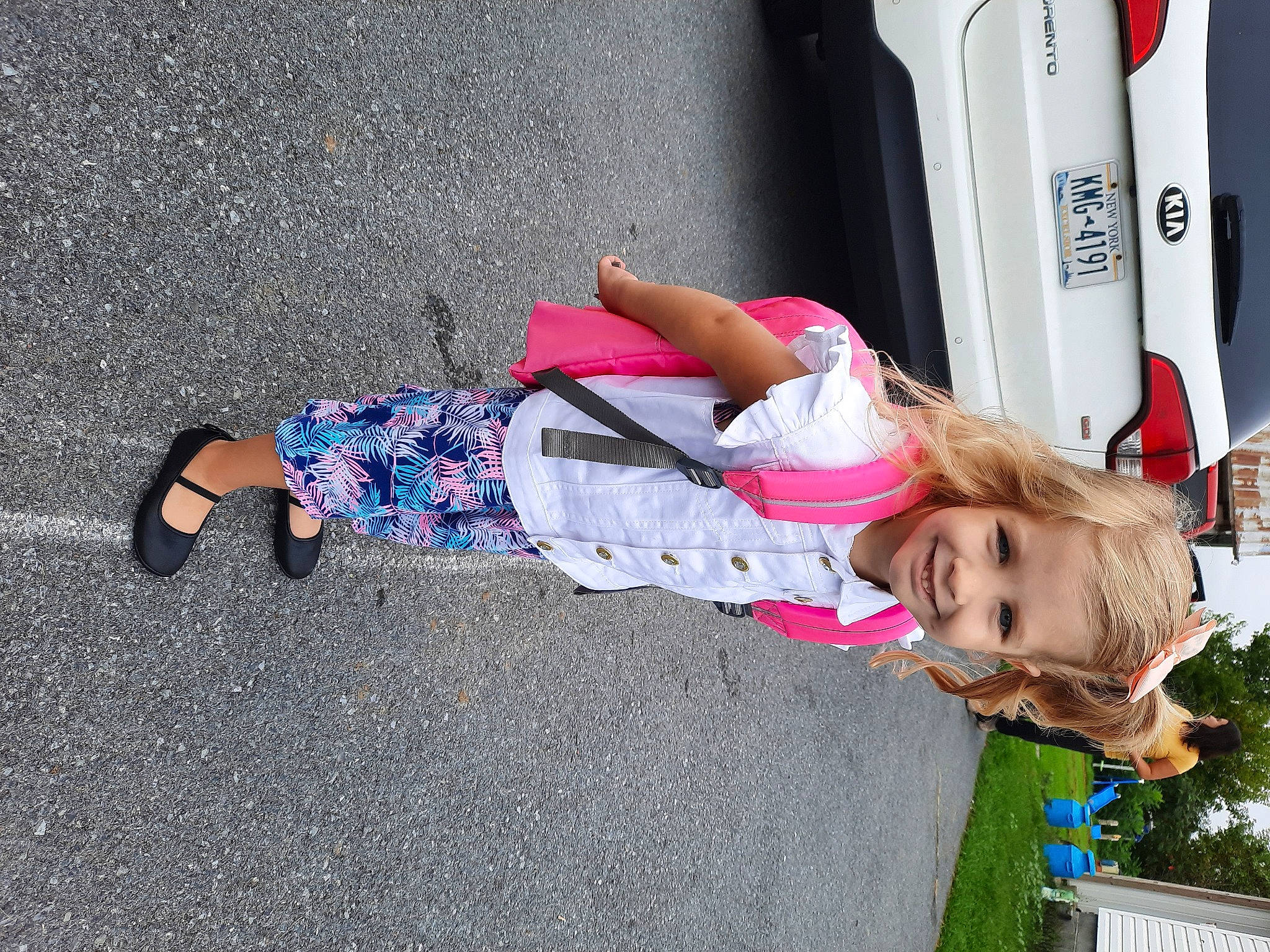 Rayna joined the competition — help win amazing prizes! asphalt, child, city, concrete, fun, grass, human_leg, human_settlement, joy, leisure, magenta, person, plant, recreation, road, road_surface, sidewalk, sitting, street, toddler