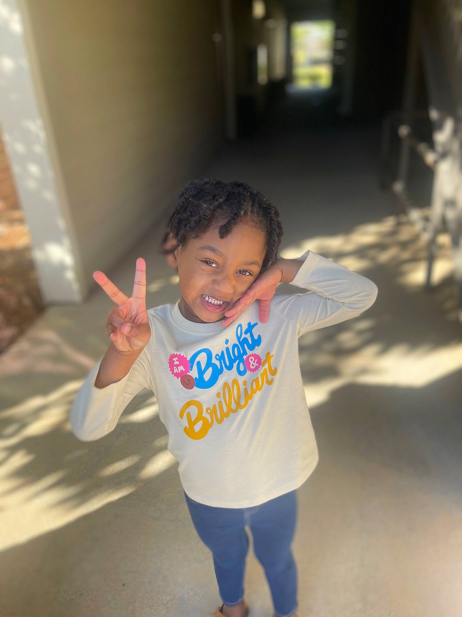 Kensley is registered to the contest to win money with this photo: baby_toddler_clothing, barefoot, child, finger, flash_photography, floor, flooring, fun, gesture, happy, joy, leisure, nose, person, skin, sleeve, smile, standing, t_shirt, thumb