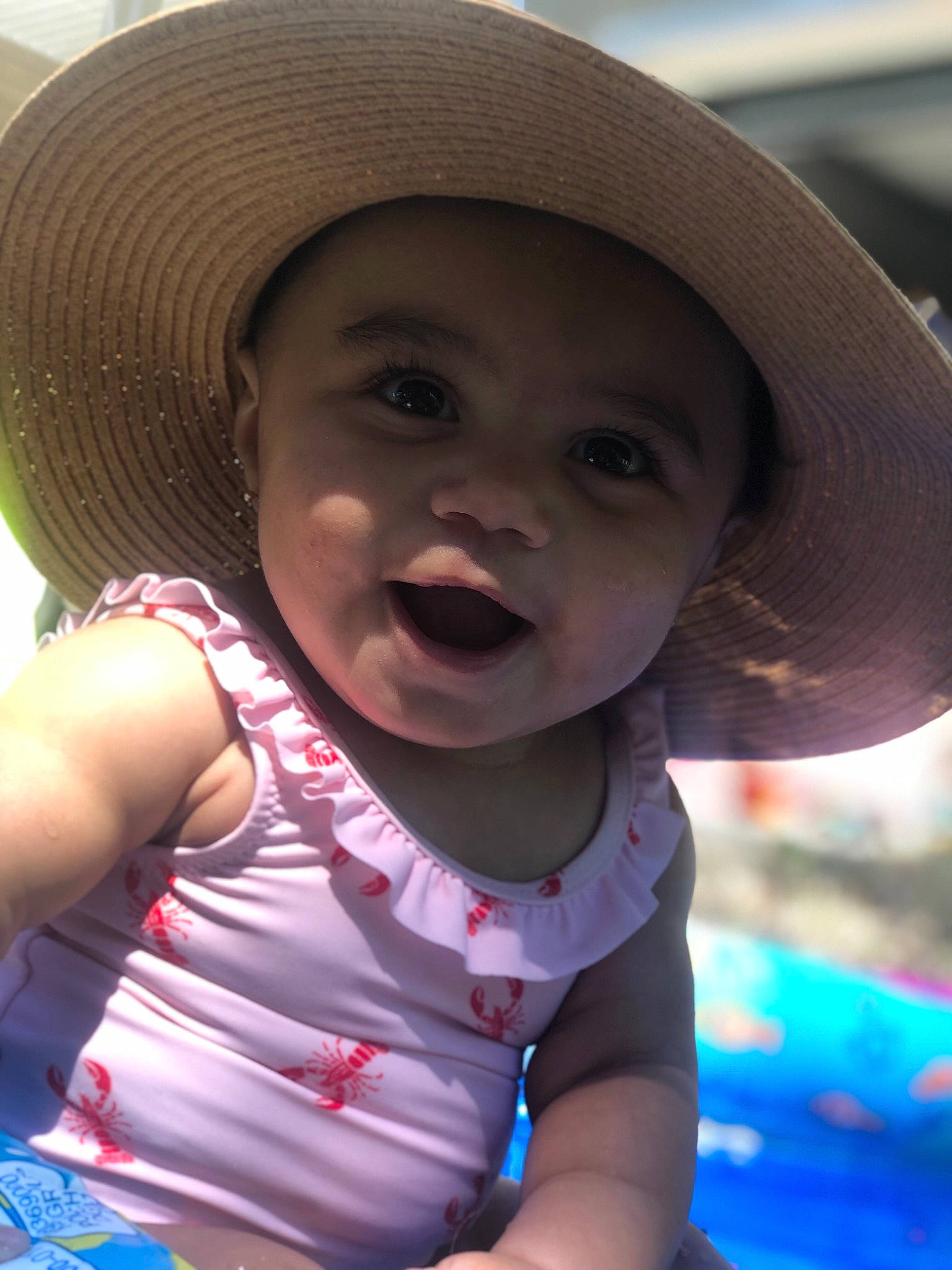 Joelle is registered to the contest to win money with this photo: baby, cheek, child, chin, eye, face, facial_expression, fashion_accessory, fun, hat, head, headgear, lip, mouth, person, skin, smile, summer, sun_hat, toddler