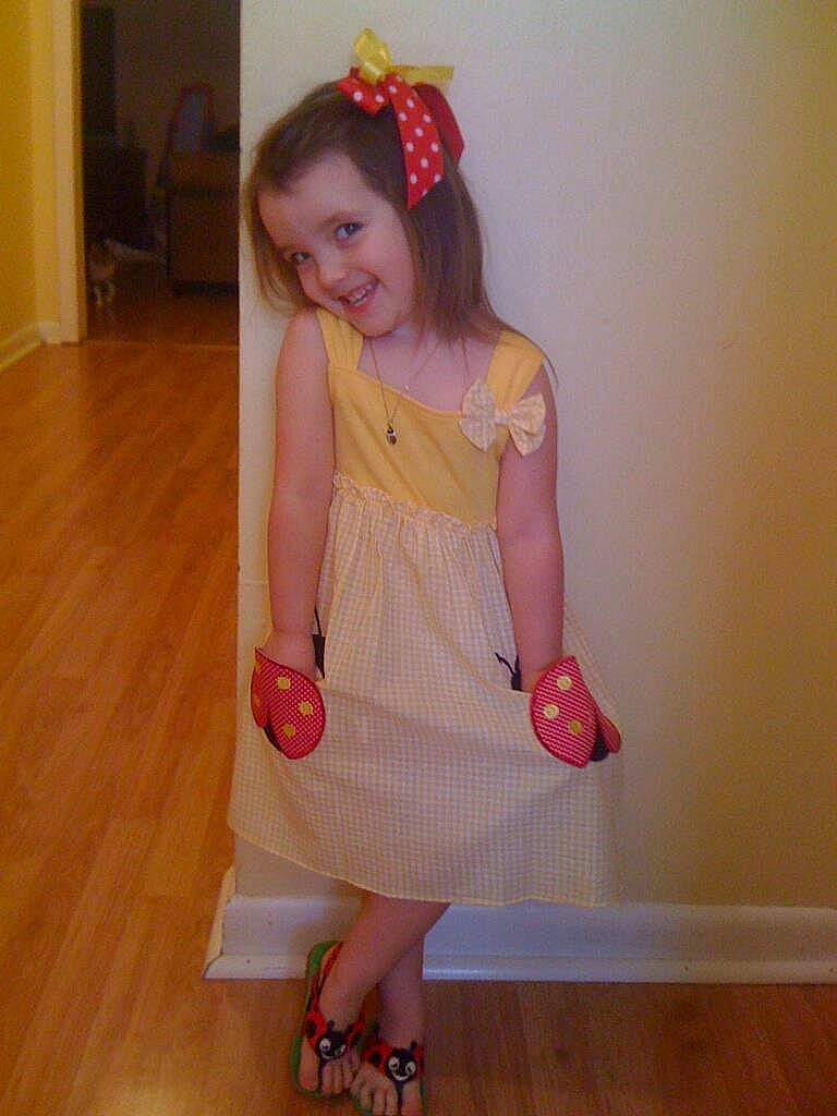 Jane is registered to the contest to win money with this photo: day_dress, dress, face, fashion_design, flooring, hair, happy, head, headgear, joy, knee, leg, long_hair, neck, person, pink, sleeve, smile, thigh, trunk