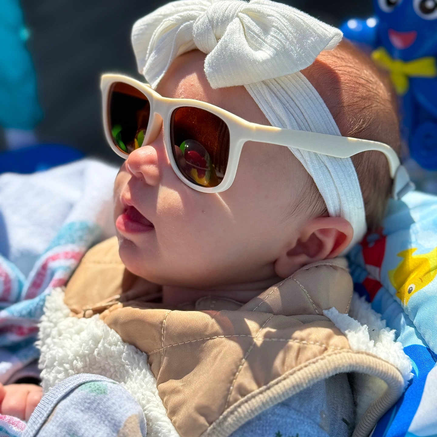Gracelynn is registered to the contest to win money with this photo: accessories, baby, bodypart, bonnet, cap, clothing, coat, face, finger, glasses, hand, hat, head, jacket, newborn, person, photography, portrait, quilt, sunglasses