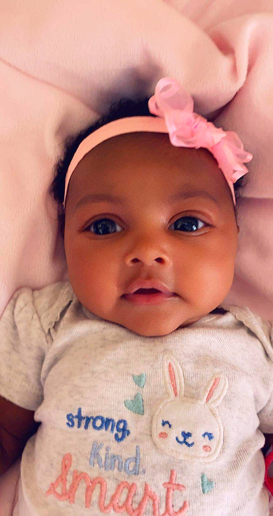 Alayna is registered to the contest to win money with this photo: baby, beauty, cheek, child, chin, close_up, ear, eye, eyebrow, face, forehead, head, headwear, human, lip, mouth, nose, organ, person, pink