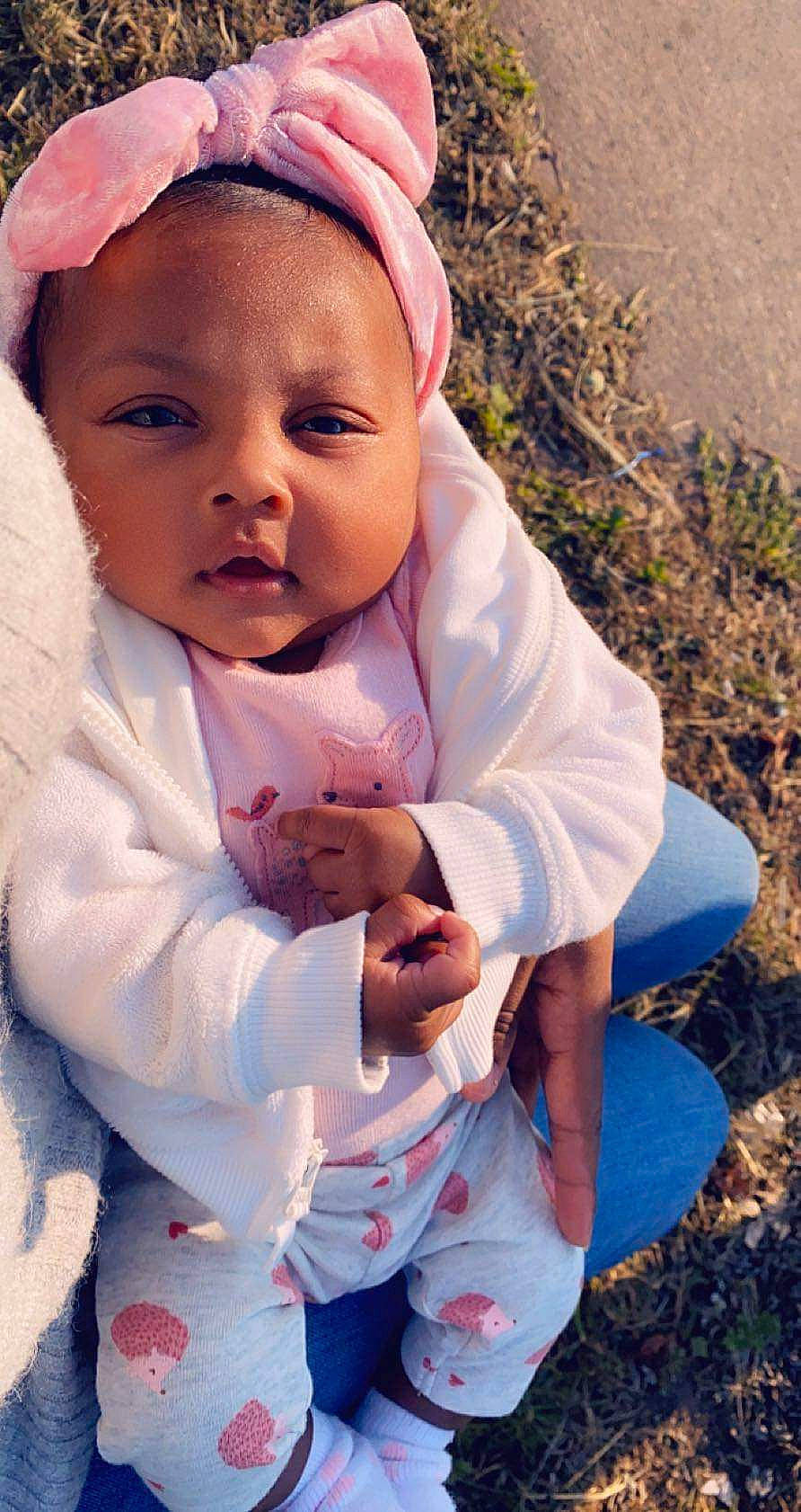 Alayna is registered to the contest to win money with this photo: baby, cheek, child, eye, face, head, headgear, lip, outerwear, person, photography, pink, skin, smile, toddler