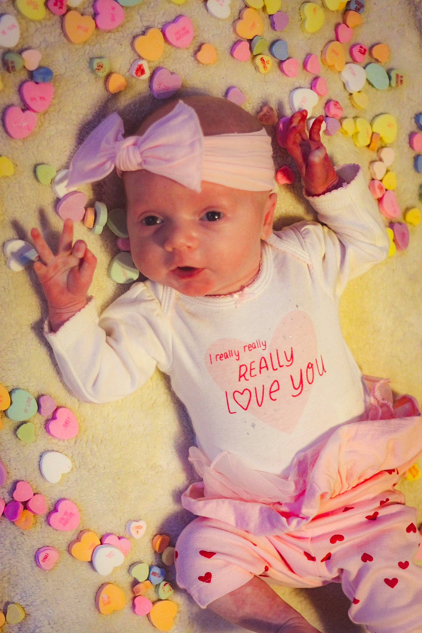 Emma is registered to the contest to win money with this photo: baby, baby_products, baby_toddler_clothing, cap, cheek, child, dress, face, facial_expression, fun, happy, head, headwear, magenta, pattern, person, pink, product, skin, sleeve