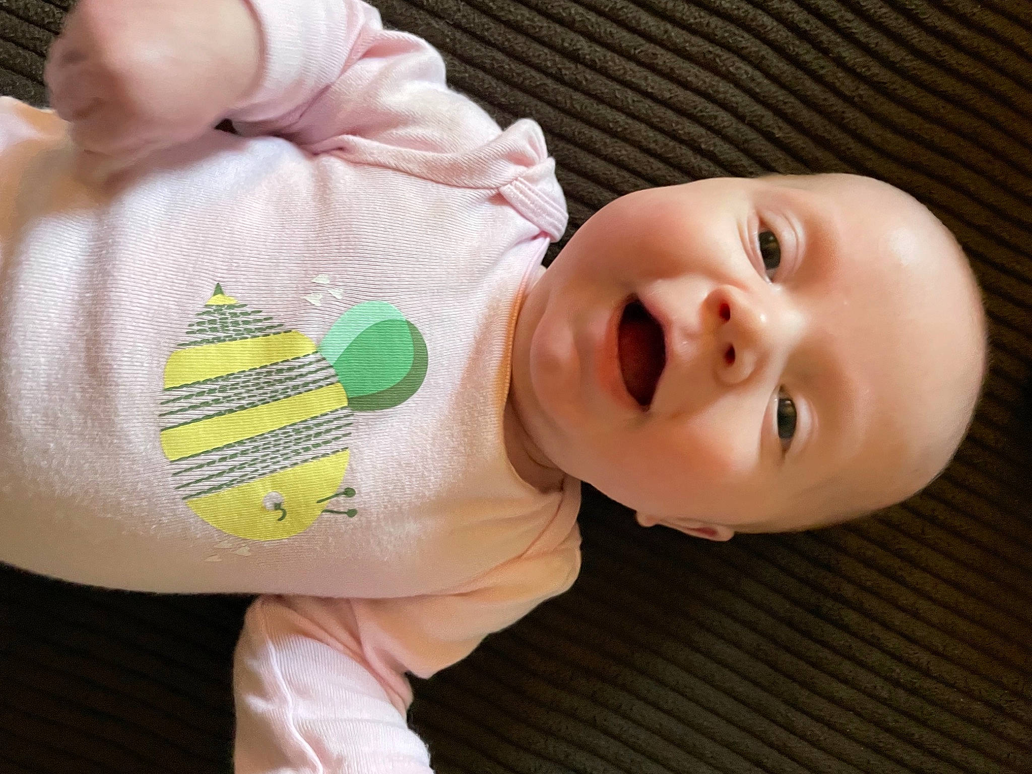 Emma is registered to the contest to win money with this photo: baby, baby_products, baby_safety, baby_toddler_clothing, cheek, child, face, finger, foot, happy, nail, nose, person, sitting, skin, sleeve, smile, textile, thumb, toddler