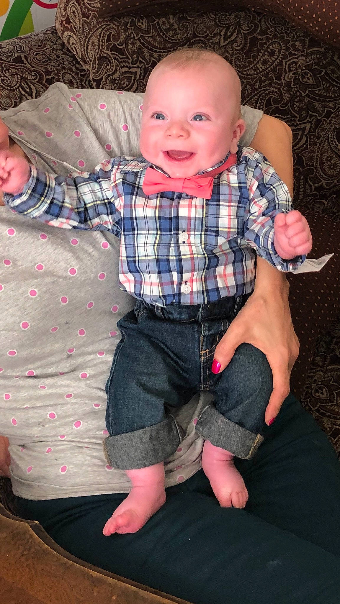 Tony is registered to the contest to win money with this photo: arm, baby, cheek, child, design, finger, fun, leg, pattern, person, plaid, sitting, toddler