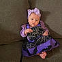 baby, child, purple_clothing, headband, bow, bat, spider_web, couch, indoor, cute, infant, sitting, portrait, costume, holiday, halloween, foot, person, smile, young_child
