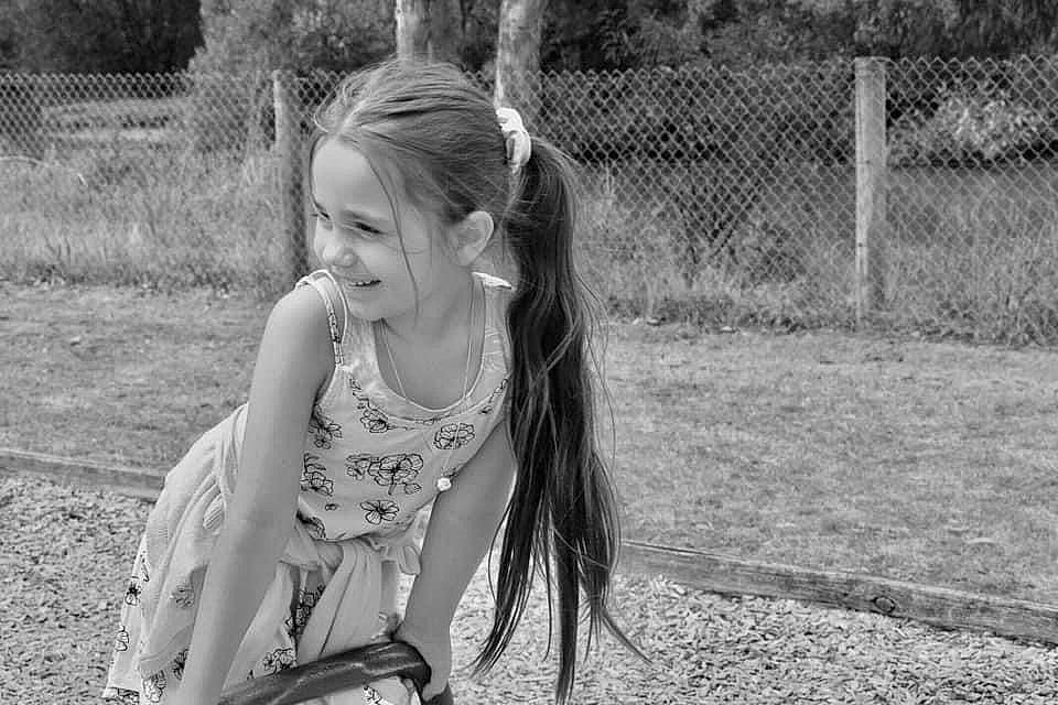 Shayla-jaide is registered to the contest to win money with this photo: beauty, black_and_white, blond, child, fence, flash_photography, fun, grass, happy, joy, leisure, long_hair, monochrome, monochrome_photography, people_in_nature, person, plant, recreation, sitting, smile