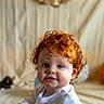 baby, child, toddler, red_hair, blue_eyes, smiling, curly_hair, portrait, indoor, white_clothing, first_birthday, banner, cute, happy, face, person, infant, celebration, soft_light, background