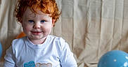 Tj joined the competition — help win amazing prizes! toddler, child, red_hair, blue_eyes, onesie, birthday, number_one, standing, smiling, indoor, balloon, fabric_background, cute, portrait, baby, milestone, celebration, person, happy, playful