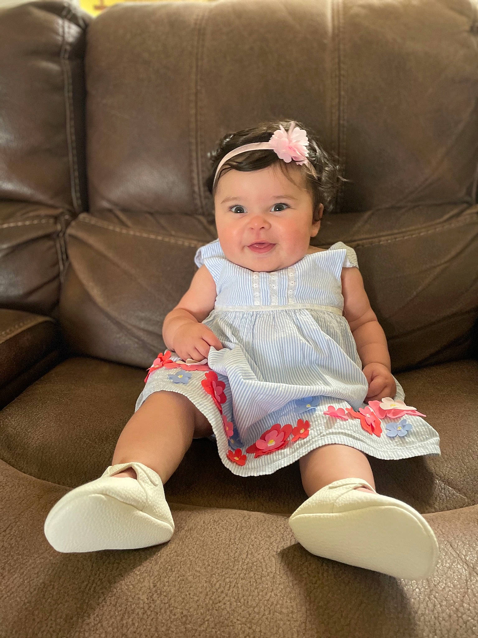Vada is registered to the contest to win money with this photo: baby_toddler_clothing, blond, cheek, child, comfort, couch, dress, embellishment, fashion, flash_photography, hairstyle, headwear, human_leg, joy, knee, person, shoe, sitting, skin, sleeve