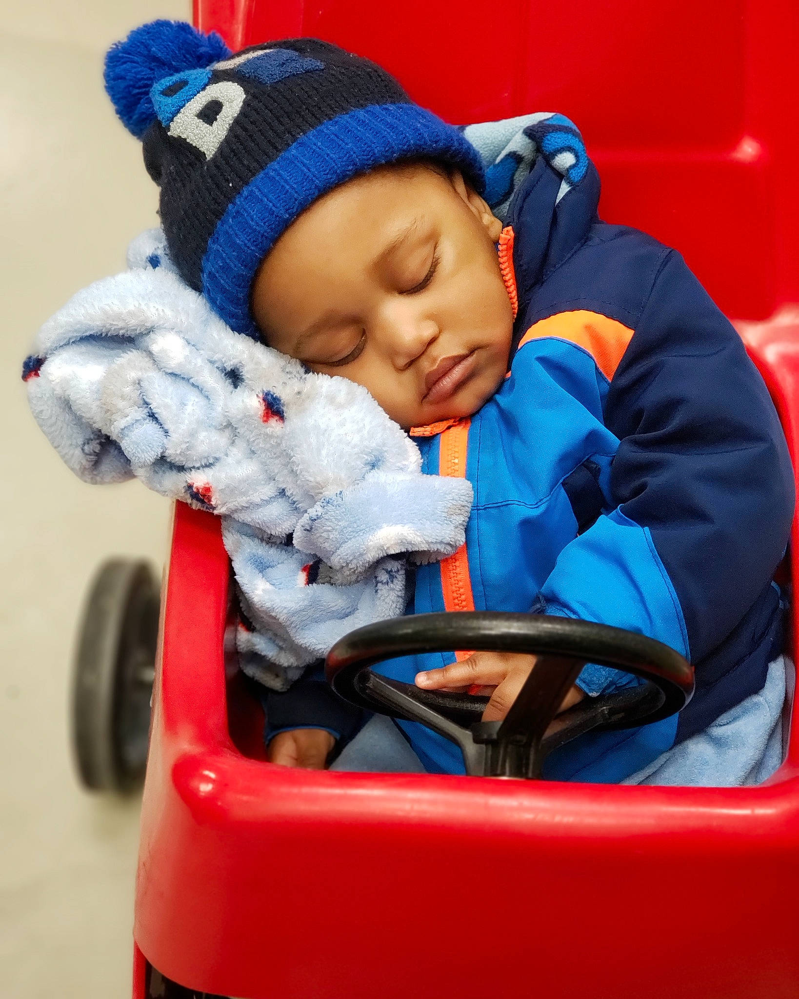 Ralph is registered to the contest to win money with this photo: baby, baby_carriage, baby_products, blue, child, headwear, person, product, toddler, vehicle