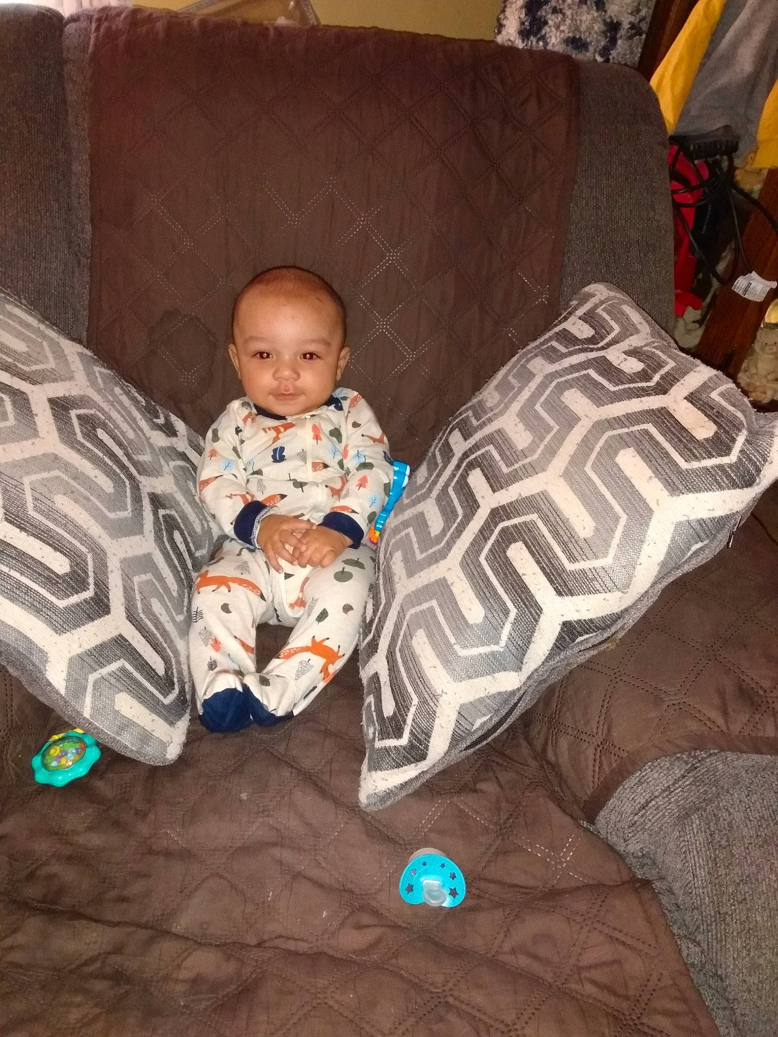 Jaylin joined the competition — help win amazing prizes! baby, baby_products, baby_toddler_clothing, brown, car_seat, child, comfort, couch, floor, flooring, furniture, lap, linens, living_room, person, pillow, sitting, textile, throw_pillow, toddler