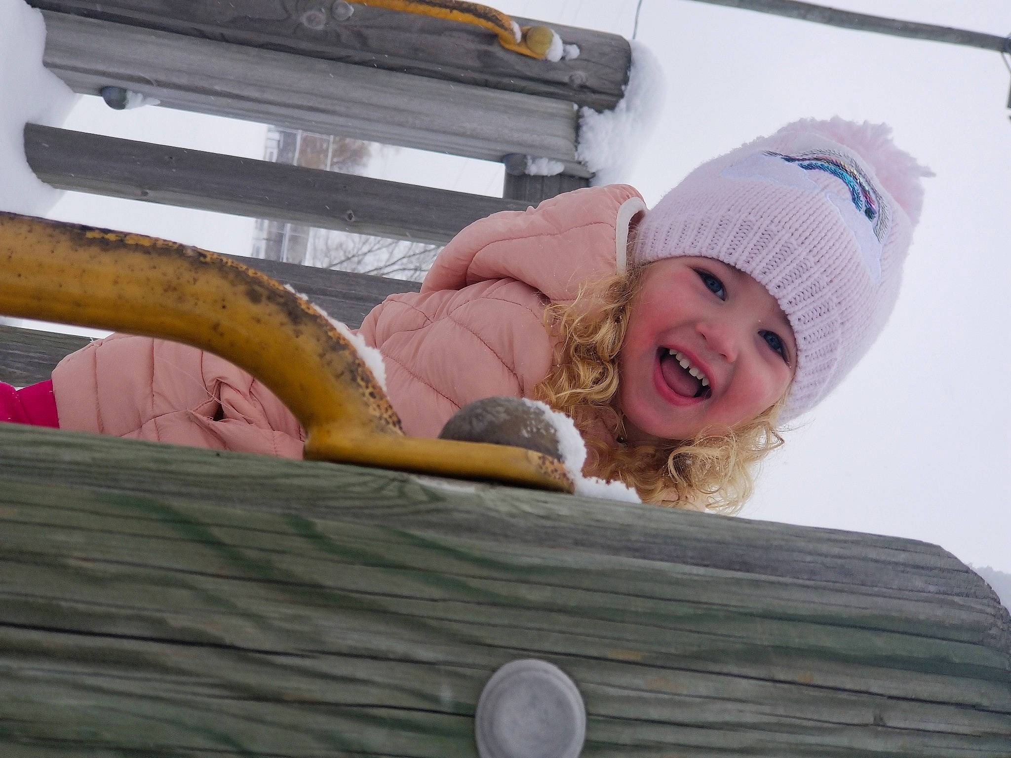 Brianne is registered to the contest to win money with this photo: automotive_exterior, bumper, cap, child, comfort, eye, fashion_accessory, fun, happy, head, headgear, headwear, leisure, person, recreation, sitting, skin, smile, toddler, travel