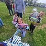 Leah is registered to the contest to win money with this photo: children, kids, easter_basket, outdoor, grass, smiling, happy, festival, family, toy, park, people, event, spring, daytime, casual_clothing, celebration, gift, crowd, nature