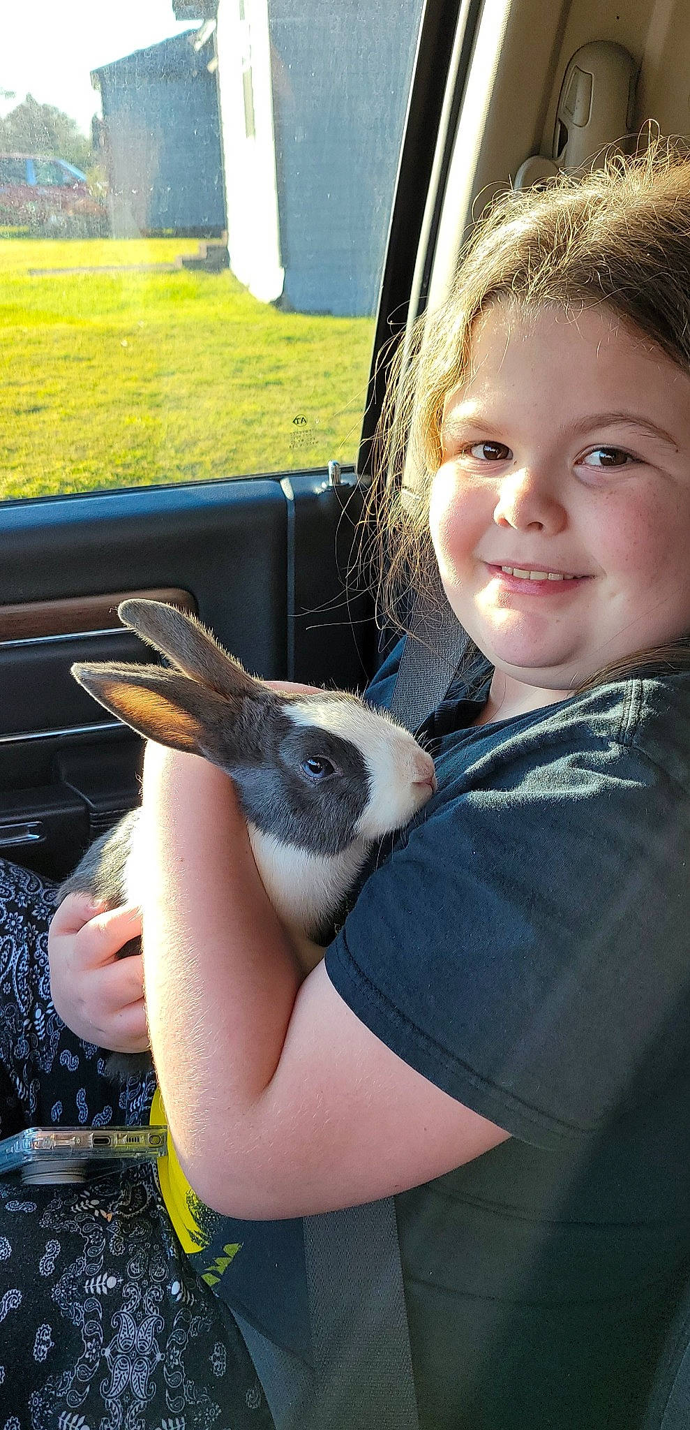 Audrey joined the competition — help win amazing prizes! beak, bird, brown_hair, finger, grass, hand, happy, joy, leisure, neck, penguin, perching_bird, person, recreation, seabird, sitting, smile, toddler, vacation, vehicle_door