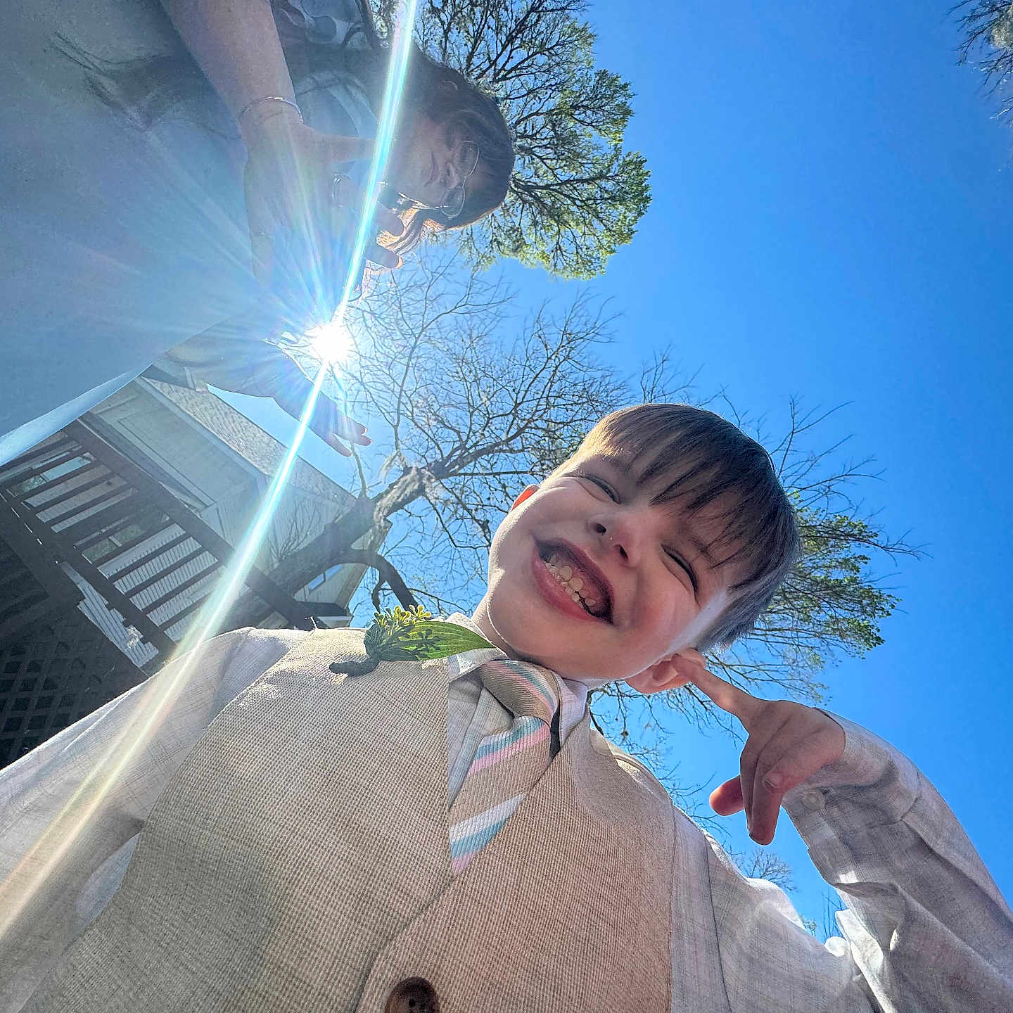 Noah Thompson joined the competition — help win amazing prizes! boy, building, child, daylight, deck, glasses, happy, lens_flare, nature, outdoor, person, phone, portrait, sky, smile, sunlight, tie, tree, vest, woman