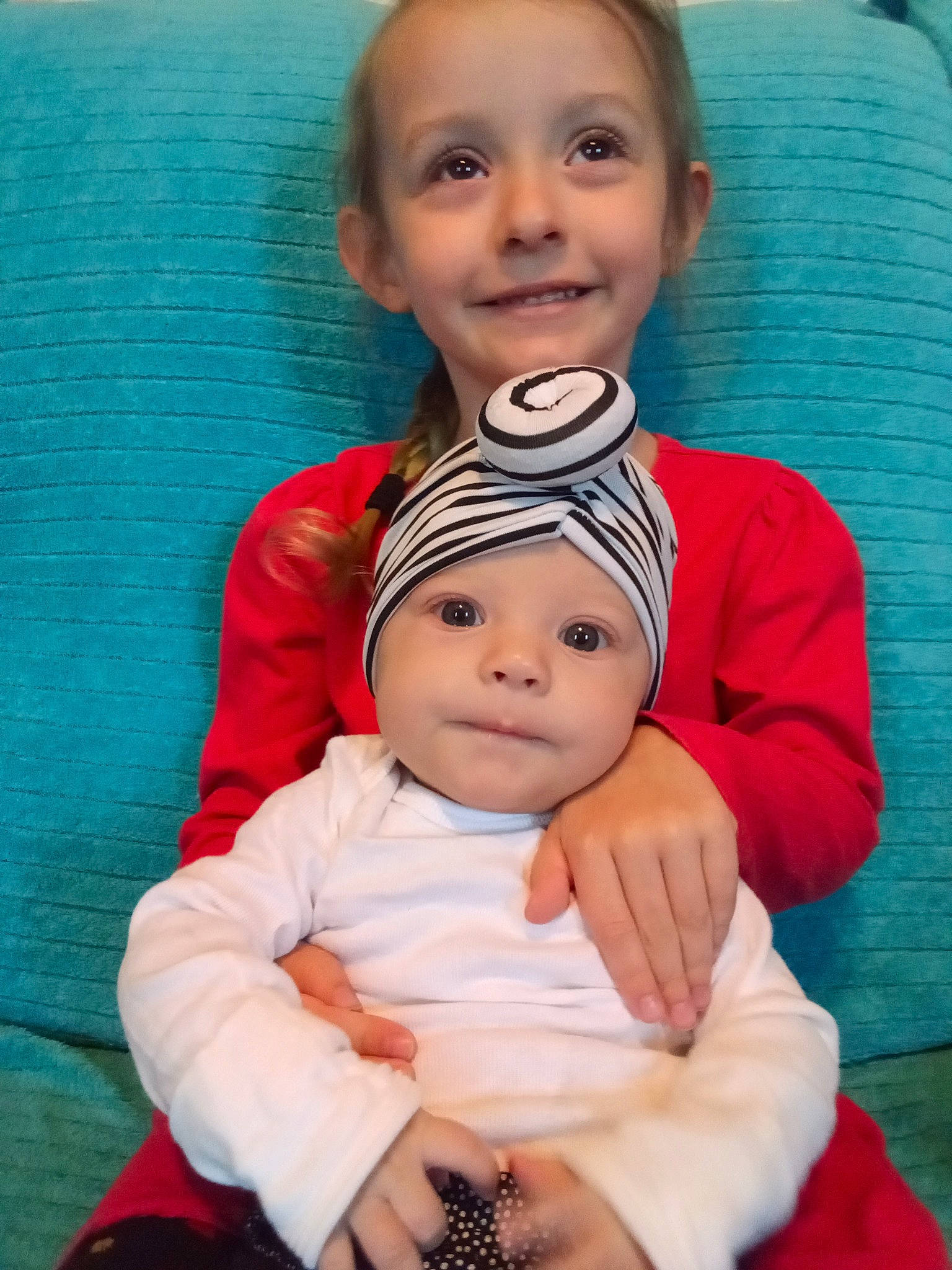 Kelly Rose is registered to the contest to win money with this photo: baby_toddler_clothing, blue, cheek, eye, eyebrow, face, facial_expression, hair, hairstyle, hand, head, headwear, human_body, joy, lip, mouth, nose, organ, person, skin