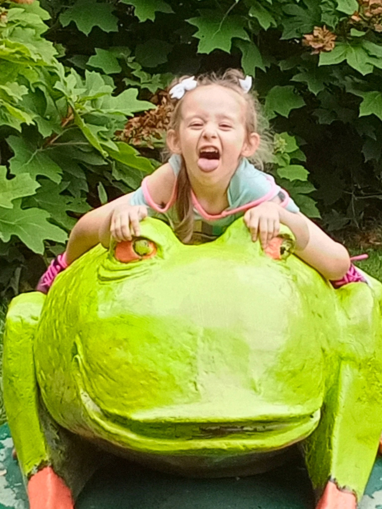 Mia Grace is registered to the contest to win money with this photo: baby_toddler_clothing, botany, child, eye, fun, garden, grass, green, happy, laugh, leisure, people_in_nature, person, plant, recreation, sitting, smile, t_shirt, terrestrial_plant, toddler