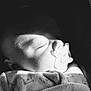 baby, pacifier, sleeping, black_and_white, blanket, face, infant, close_up, soft_light, peaceful, child, cozy, portrait, newborn, cute, peace, resting, clothing, indoors, quiet