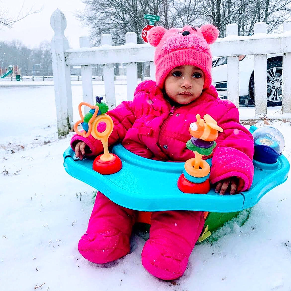 Jay is registered to the contest to win money with this photo: child, freezing, fun, headgear, magenta, outdoor_play_equipment, outerwear, person, pink, play, playing_in_the_snow, purple, recreation, snow, toddler, toy, vehicle, winter