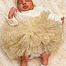 baby, sleeping, tutu, headband, blanket, soft_texture, infant, white_clothing, socks, cute, adorable, resting, cozy, newborn, golden, sparkle, portrait, child, peaceful, laying_down