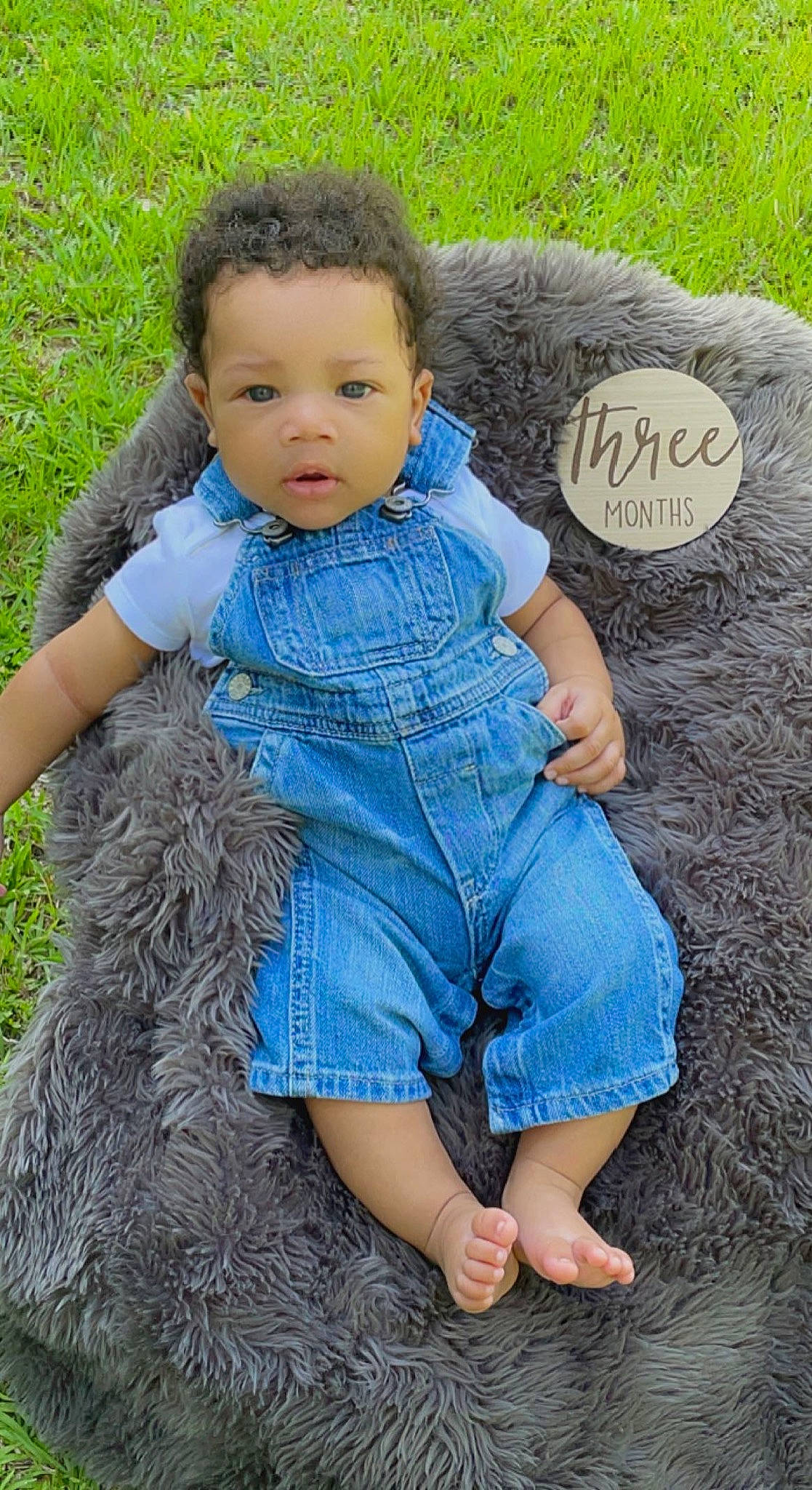 Kace is registered to the contest to win money with this photo: arm, azure, baby_toddler_clothing, child, denim, electric_blue, fashion, finger, grass, grass_family, hand, happy, pattern, people_in_nature, person, sitting, skin, sleeve, textile, toddler