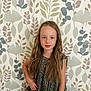 child, girl, long_hair, wavy_hair, smile, posing, standing, wallpaper, botanical, leaves, pattern, indoor, casual_clothing, dress, portrait, young, confident, hand_on_hip, looking_at_camera, freckles