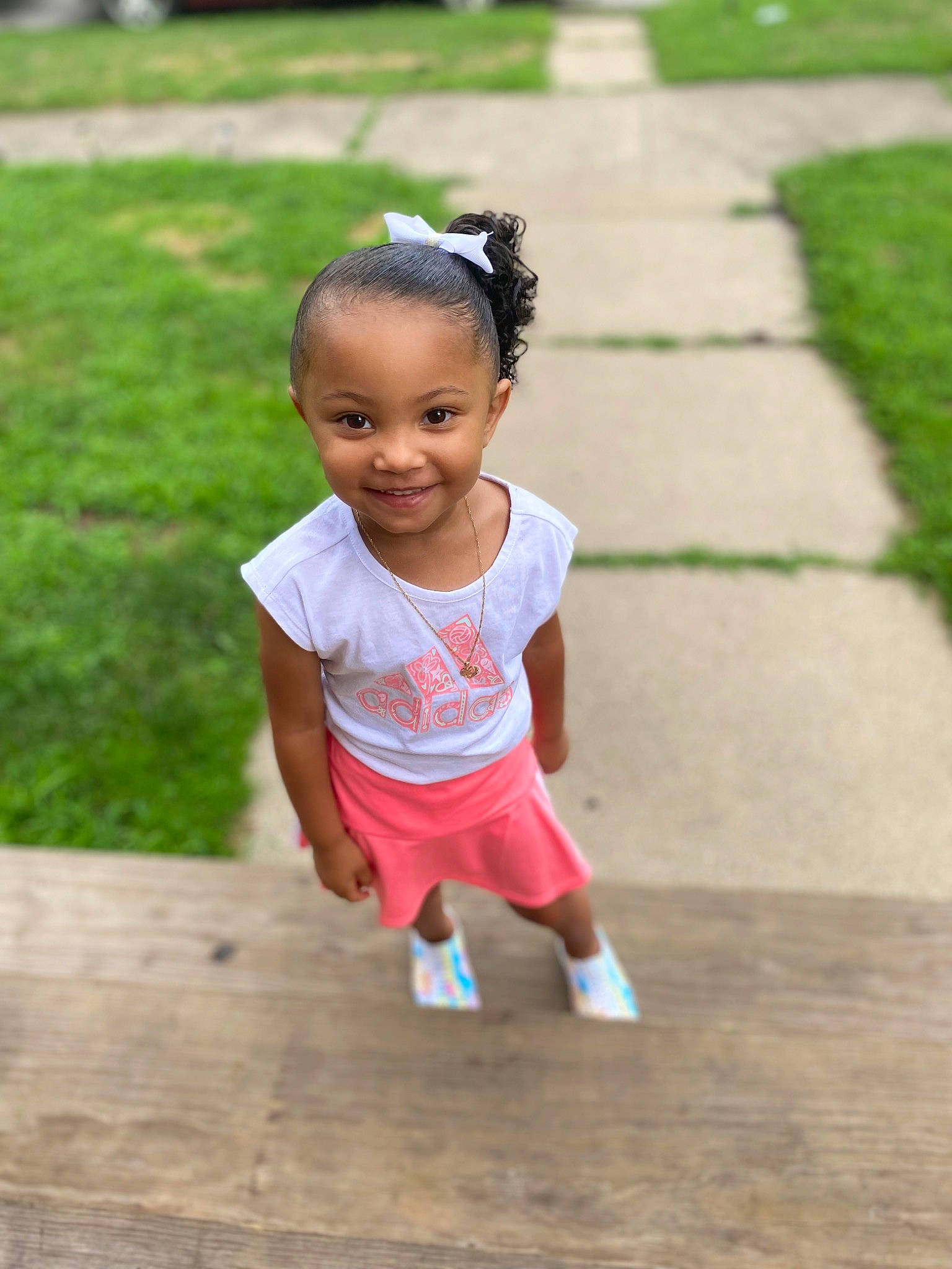 Kalee is registered to the contest to win money with this photo: asphalt, baby, baby_toddler_clothing, dress, eye, flooring, footwear, fun, grass, happy, head, joy, leaf, leisure, person, public_space, road, skin, smile, toddler