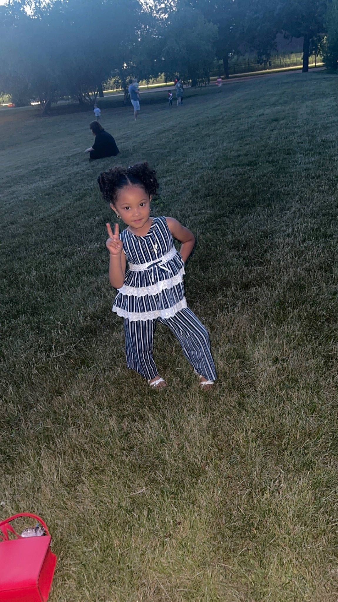 Kalee is registered to the contest to win money with this photo: asphalt, child, field, fun, grass, grassland, happy, horizon, landscape, lawn, leisure, meadow, people_in_nature, person, recreation, shadow, sitting, sky, soil, toddler