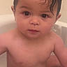 baby, child, bathtub, bath, wet_hair, skin, naked, sitting, water, cute, face, curious, indoors, infant, portrait, young_child, person, toddler, expression, head