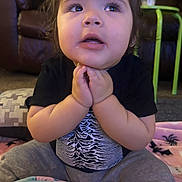 Lilith is registered to the contest to win money with this photo: toddler, child, baby, hands, face, eyes, blanket, toy, indoor, sitting, clothing, curious, expression, person, soft_toy, carpet, couch, adult, home, casual