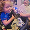 Loyal is registered to the contest to win money with this photo: child, children, curly_hair, kitten, blanket, smile, indoor, mickey_mouse, bottle, happy, toy, cozy, person, young, curled_hair, sitting, hoodie, furniture, light, family