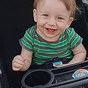 Loyal joined the competition — help win amazing prizes! toddler, baby, child, smiling, happy, stroller, green_shirt, striped_shirt, face, person, infant, cute, young_child, playful, seated, outdoor_gear, graco, hand, blue_eyes, casual_clothing