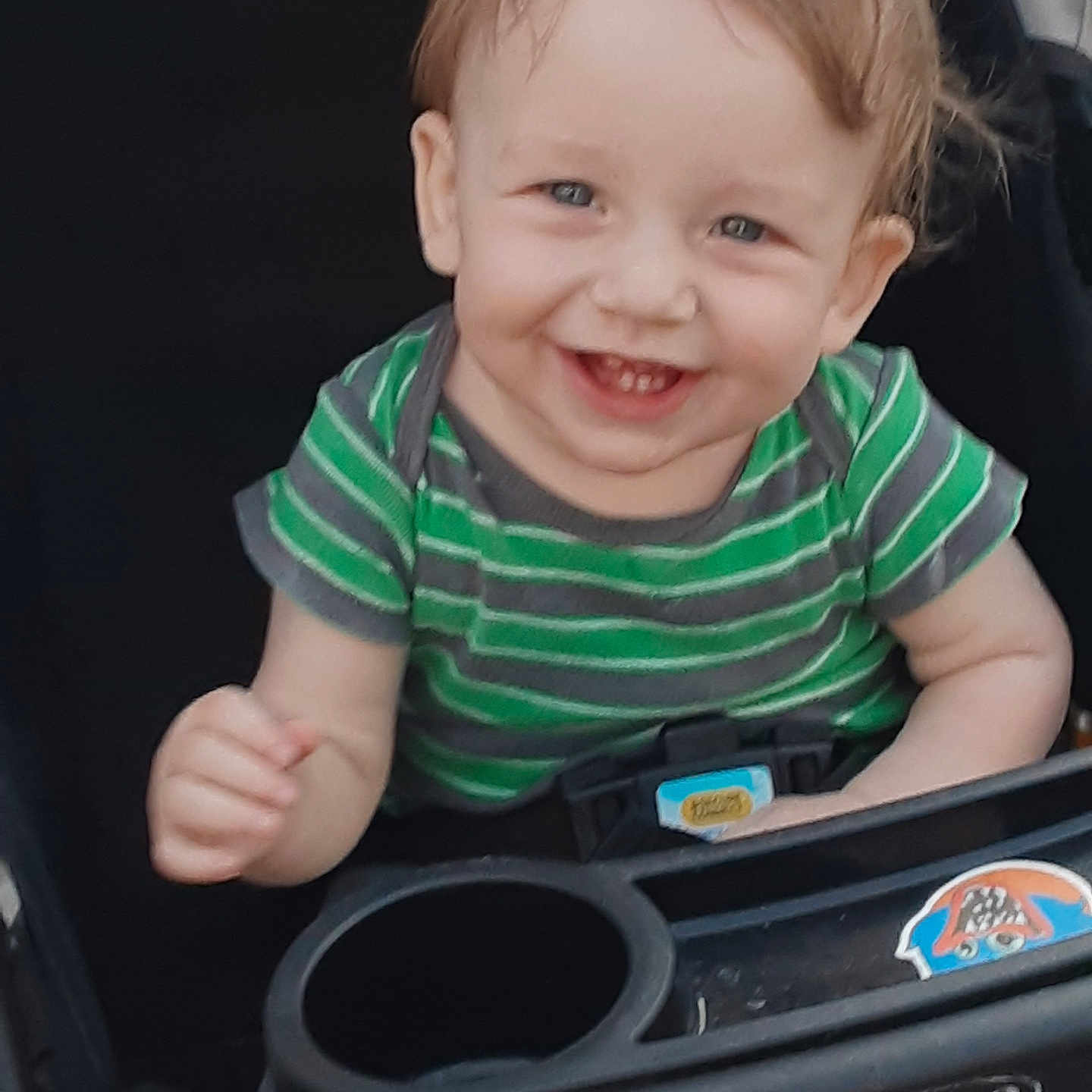 Loyal joined the competition — help win amazing prizes! toddler, baby, child, smiling, happy, stroller, green_shirt, striped_shirt, face, person, infant, cute, young_child, playful, seated, outdoor_gear, graco, hand, blue_eyes, casual_clothing