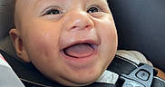 Gabriel joined the competition — help win amazing prizes! baby, child, infant, smiling, happy, laughing, portrait, face, eyes, tongue, car_seat, safety_harness, vehicle, automobile, interior, warning_label, seatbelt, travel, indoors, close_up