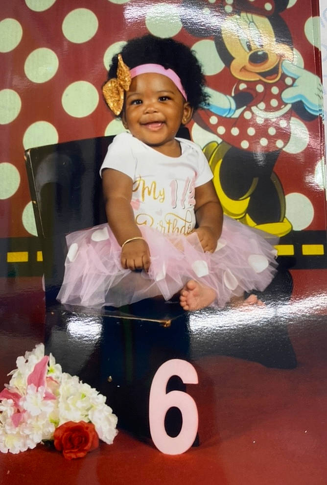 Riley is registered to the contest to win money with this photo: baby, baby_toddler_clothing, birthday, cake_decorating, child, curtain, event, flower, fun, happy, hat, joy, party, party_supply, person, pink, smile, sugar_cake, sun_hat, sweetness
