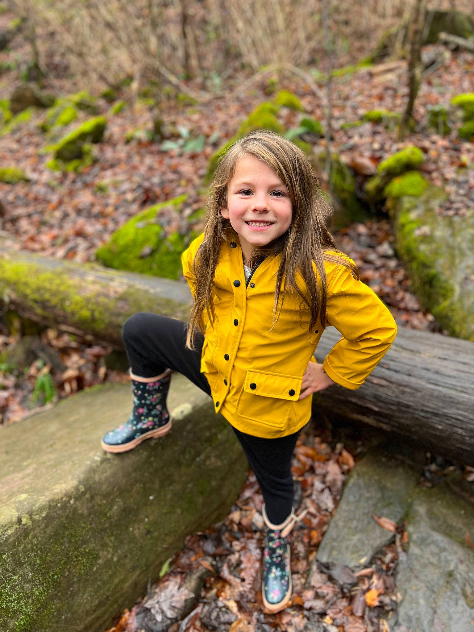 Danielle is registered to the contest to win money with this photo: eye, face, forest, fun, grass, hair, happy, head, joy, leaf, leg, leisure, natural_landscape, outerwear, people_in_nature, person, plant, smile, sneakers, toddler