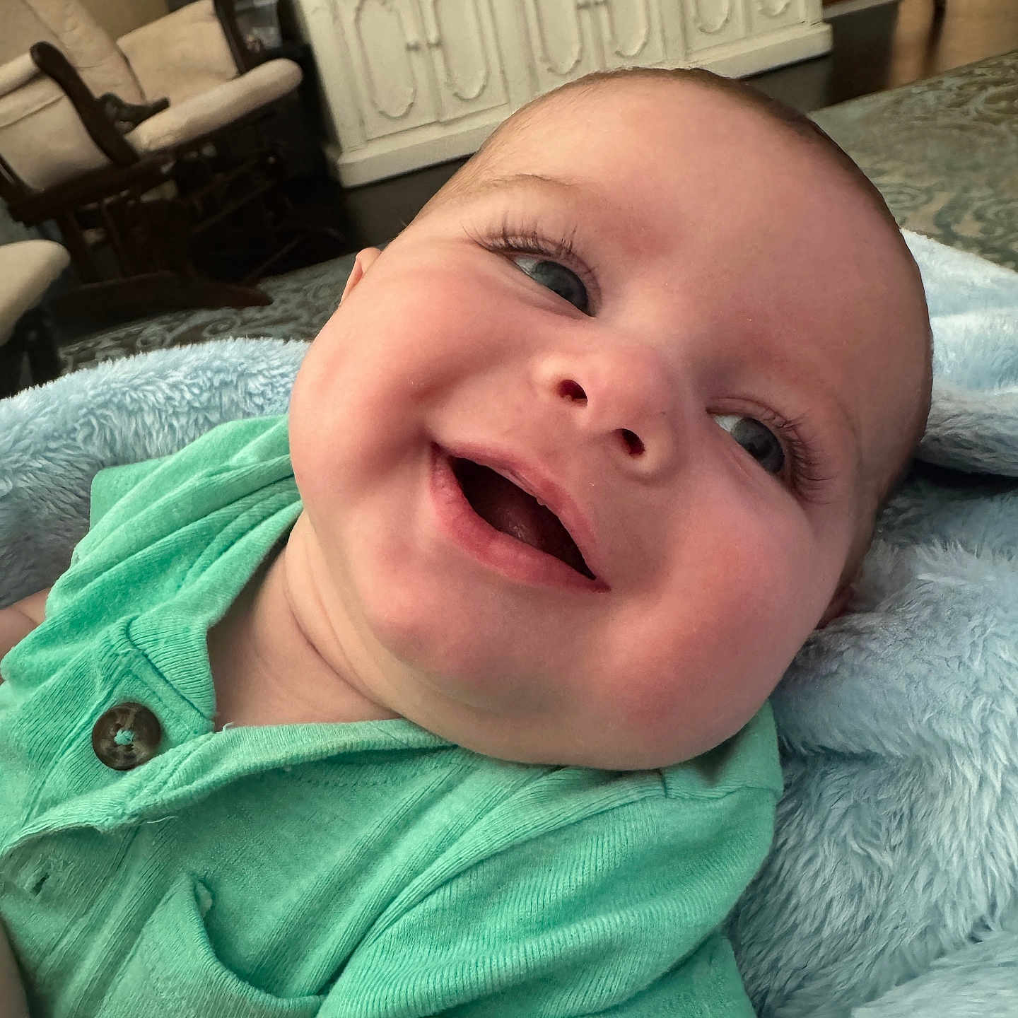 Brandon joined the competition — help win amazing prizes! baby, blanket, child, closeup, couch, cozy, cute, expression, face, furniture, green_shirt, happy, home, indoor, infant, person, portrait, skin, smile, soft_texture