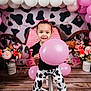 balloon, child, clothing, face, female, flower, flowerarrangement, flowerbouquet, footwear, girl, head, indoors, interiordesign, people, person, photography, plant, portrait, purple, sitting