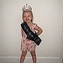 Chloe joined the competition — help win amazing prizes! accessories, child, clothing, crown, dress, face, female, footwear, girl, head, jewelry, lady, person, photography, portrait, sandal, sash, shoe, shorts, tiara