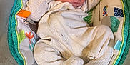 Tucker is registered to the contest to win money with this photo: baby, sleeping, onesie, infant, cushion, baby_seat, pattern, soft, comfort, peaceful, child, indoor, cozy, resting, cute, newborn, person, fabric, colorful, toddler