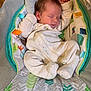 baby, sleeping, onesie, infant, cushion, baby_seat, pattern, soft, comfort, peaceful, child, indoor, cozy, resting, cute, newborn, person, fabric, colorful, toddler